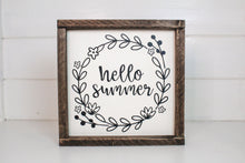 Load image into Gallery viewer, Framed sign featuring the words, "Hello summer," surrounded by leafy accents. Frame is stained in an espresso finish. Sign is painted cream with black lettering and accents