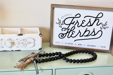 farmhouse wood bead garland in black with buffalo check ribbon and tassels