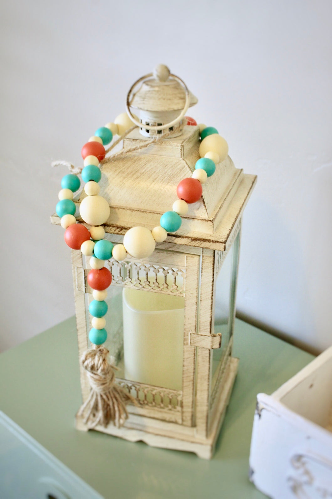 Summer Taffy Wood Bead garland with tassel and loop for hanging. Comes in a coral, cream and mint colored beads