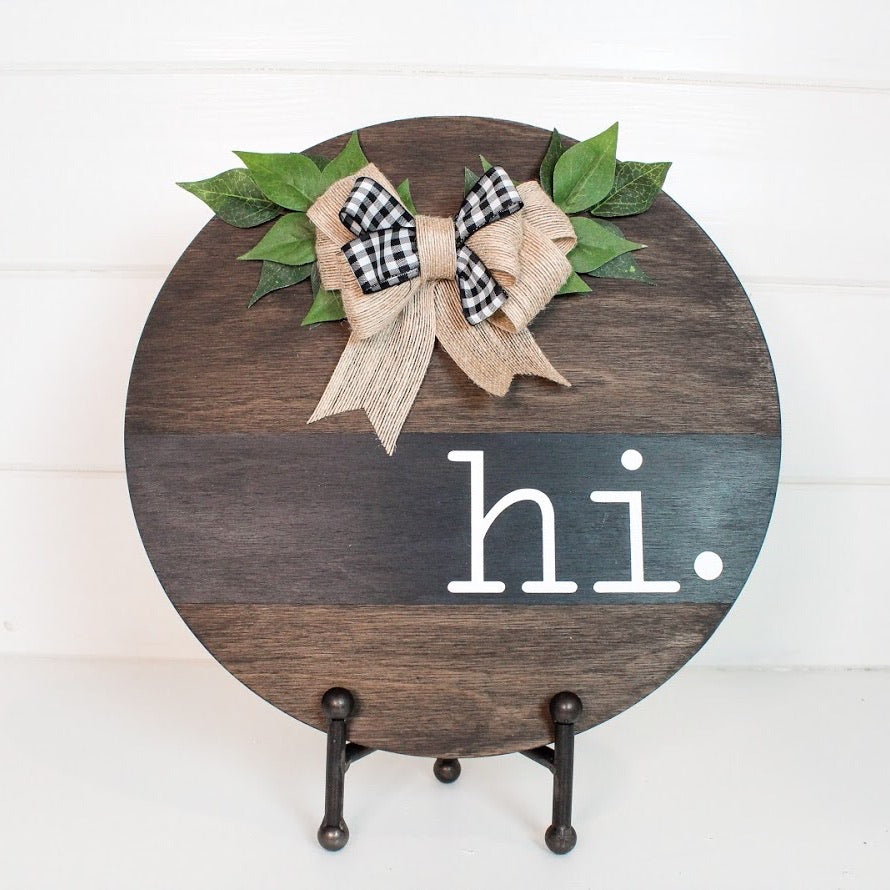 HI Wood Round Sign stained dark and embellished with a burlap and ribbon bow and green leaves